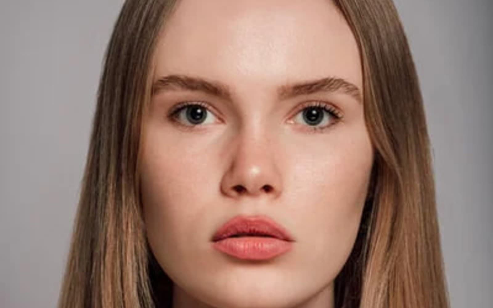 Close portrait showing even, luminous skin with visible texture