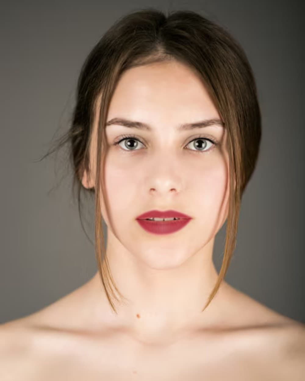 Model wearing the Le Soir Rouge look: a deep red satin lip with a quiet eye